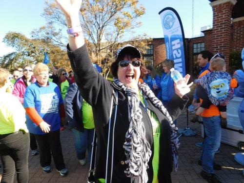 Kim DiGangi smiles and wave at Walk for PI
