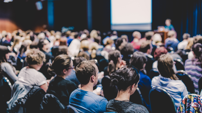audience seated in a large conference room