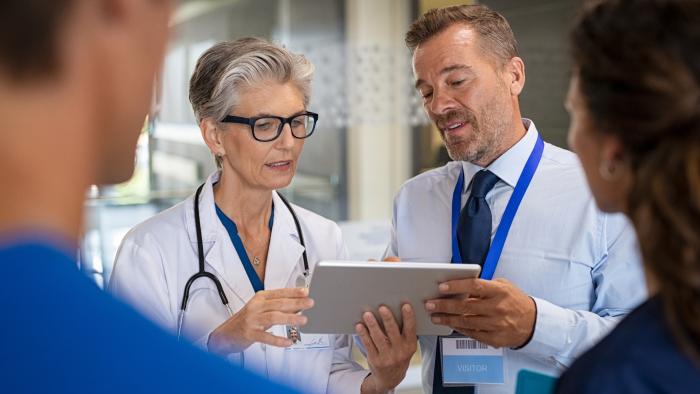 Doctors discuss a chart.